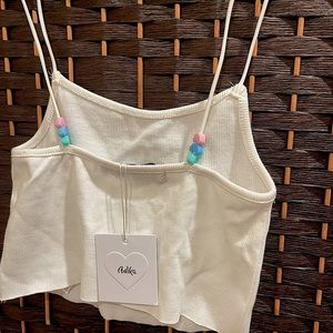 White crop top with hearts as details, summer vibes.